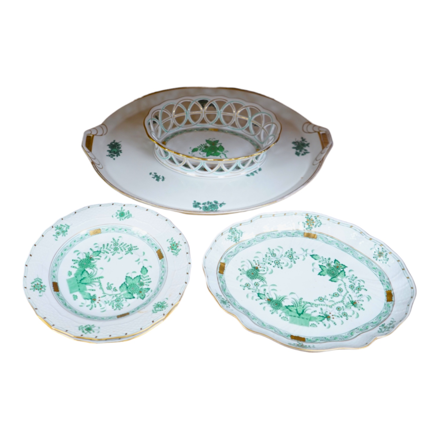 A Herend green decorated tray, 26cm wide, a similar pair of dishes and a basket, together with another larger porcelain tray, 39cm wide (5). Condition - good.